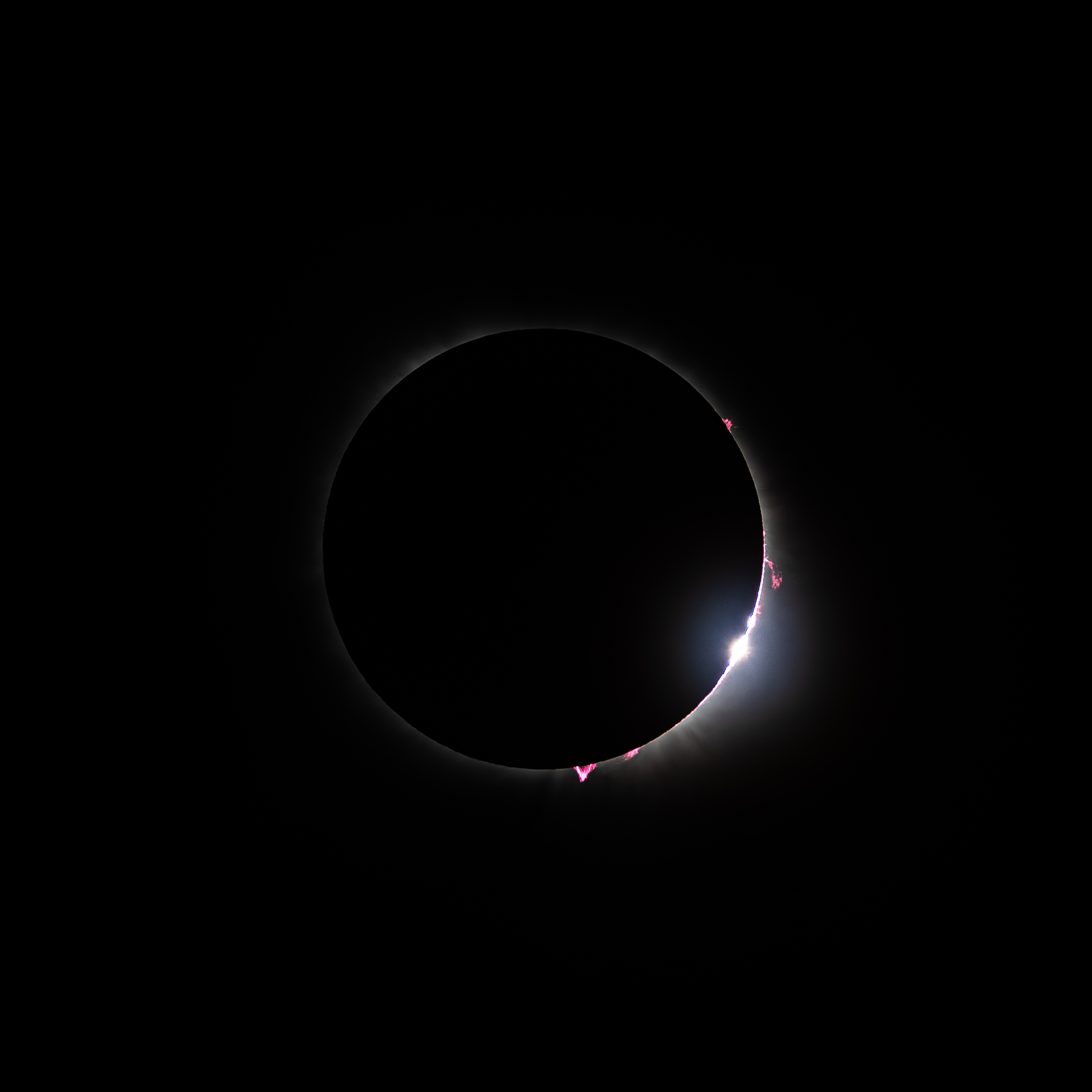 Baily's beads and solar flares at the edge of totality.