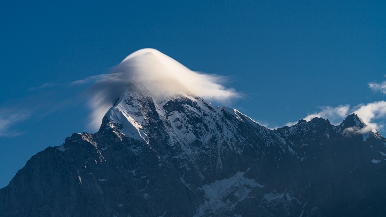 Lenticular cloud like a hat swirling above Siguniangshan.